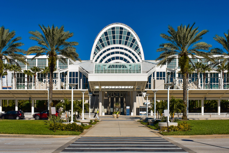 a large building with palm trees